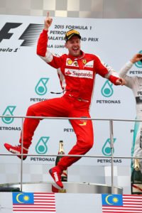 KUALA LUMPUR, MALAYSIA - MARCH 29: Sebastian Vettel of Germany and Ferrari celebrates on the podium after winning the Malaysia Formula One Grand Prix at Sepang Circuit on March 29, 2015 in Kuala Lumpur, Malaysia. (Photo by Mark Thompson/Getty Images)